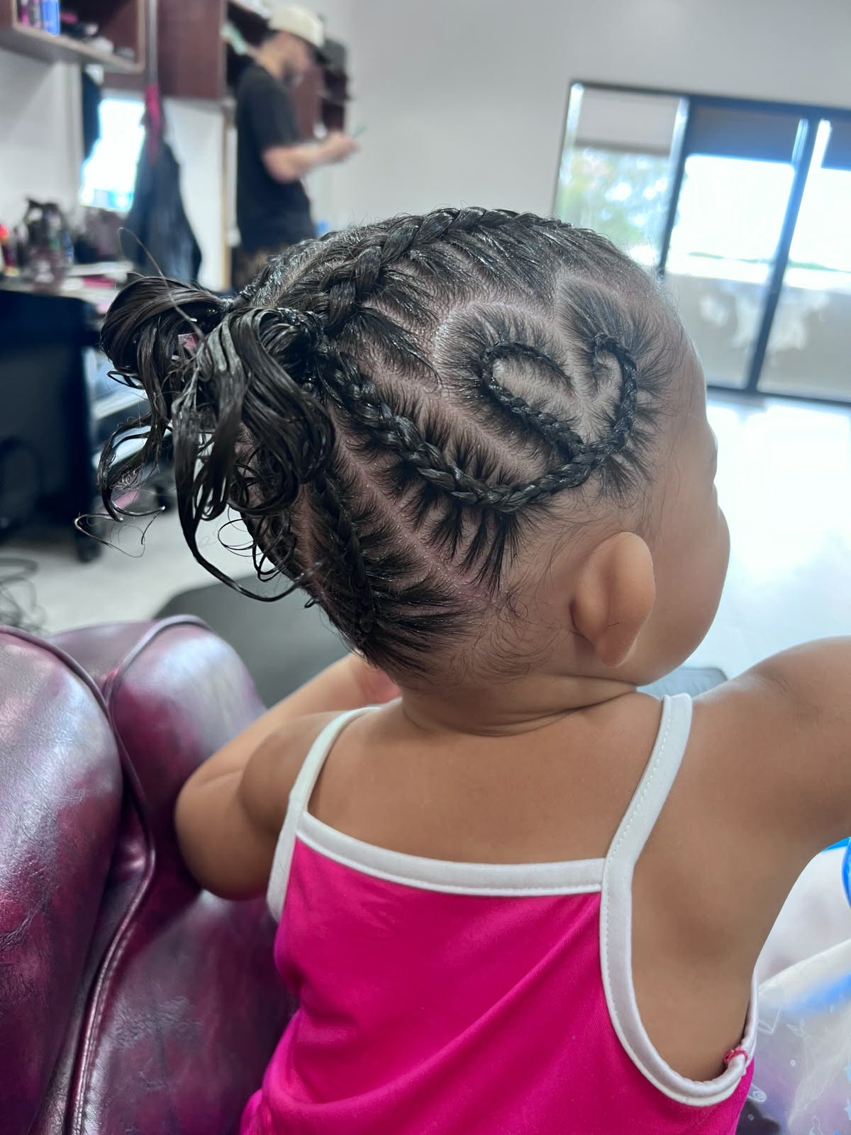 Heart braid design with a curly ponytail on a toddler