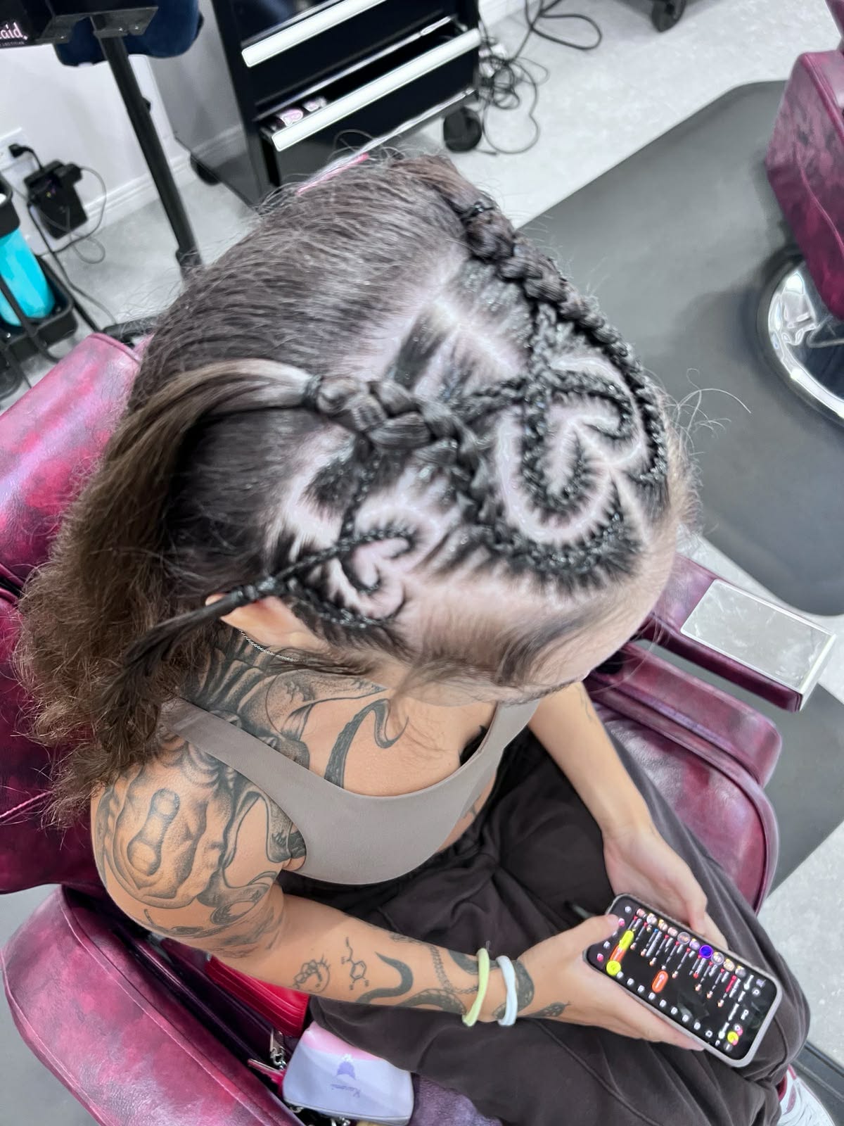 Heart-design braids woven into a half-up style