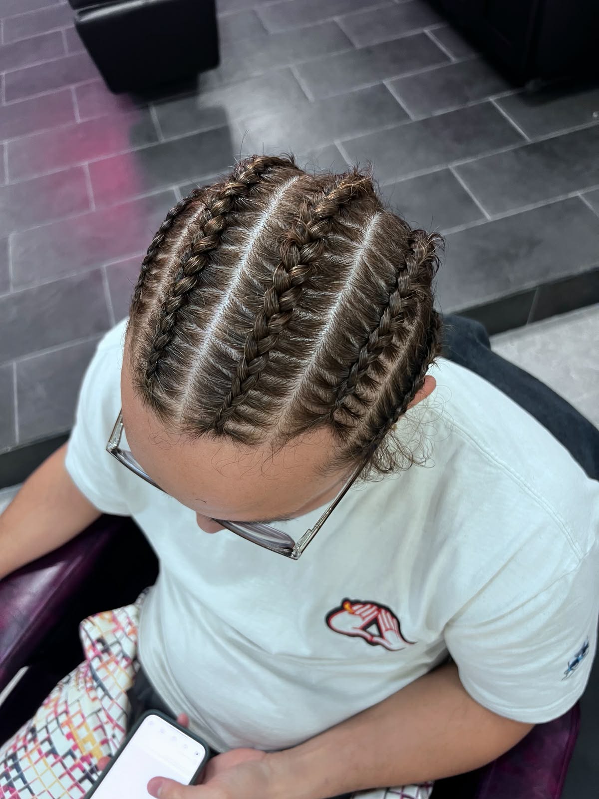 Straight-back cornrows in light brown hair